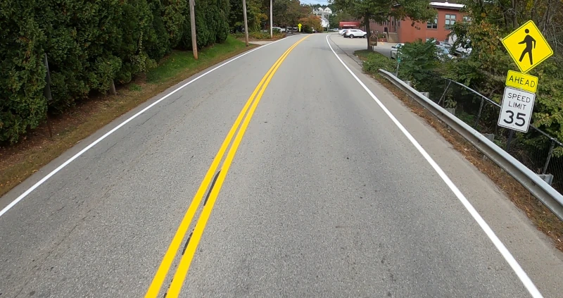 Screenshot from GoPro video showing a road and yellow signpost that can be inspected within the app.